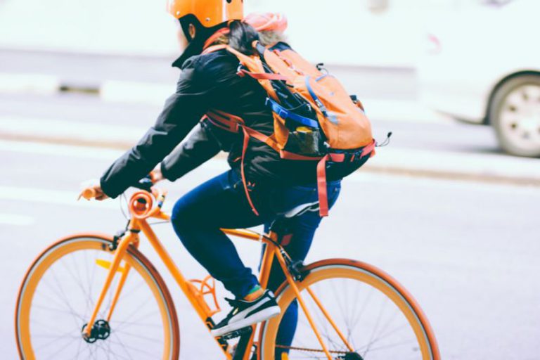 Helmet Safety Australia - closeup photo of person riding a orange bicycle