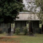 Farm Stay Australia - a small house with a metal roof in the middle of a field