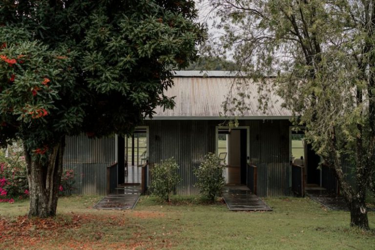 Farm Stay Australia - a small house with a metal roof in the middle of a field