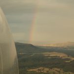 Glamping Tent Australia - a view of a rainbow from a plane window