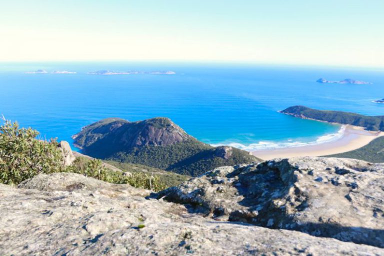 Hiking View Australia - a view of a beach from a rocky outcropping