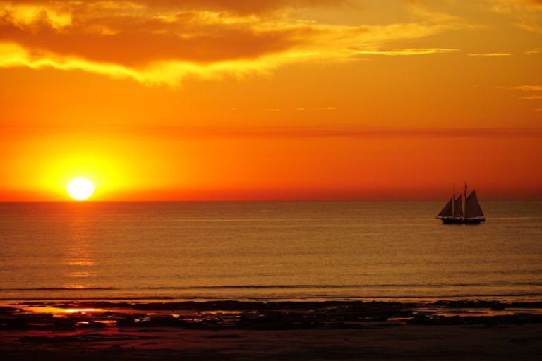 Cable Beach Australia - a sailboat in the ocean at sunset