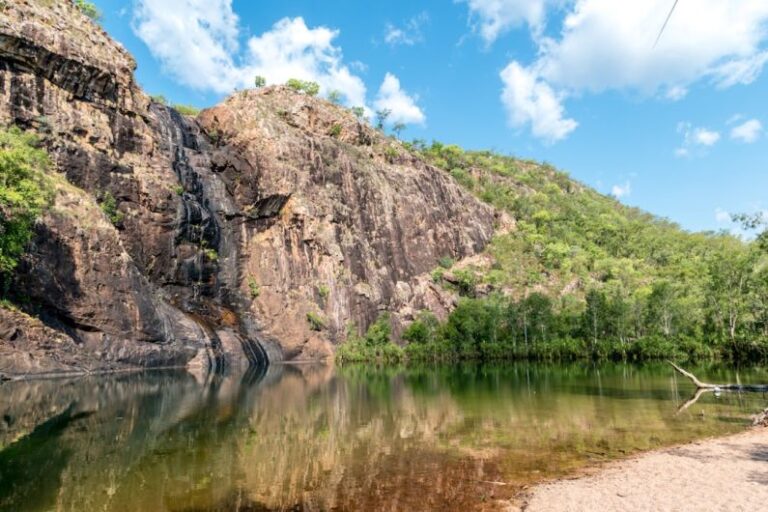 Kakadu - green and brown mountain beside river under blue sky during daytime