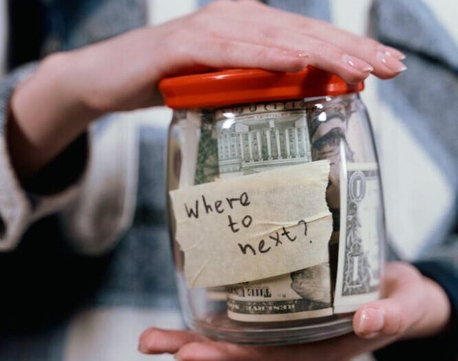 A Person Holding a Container Full of Money